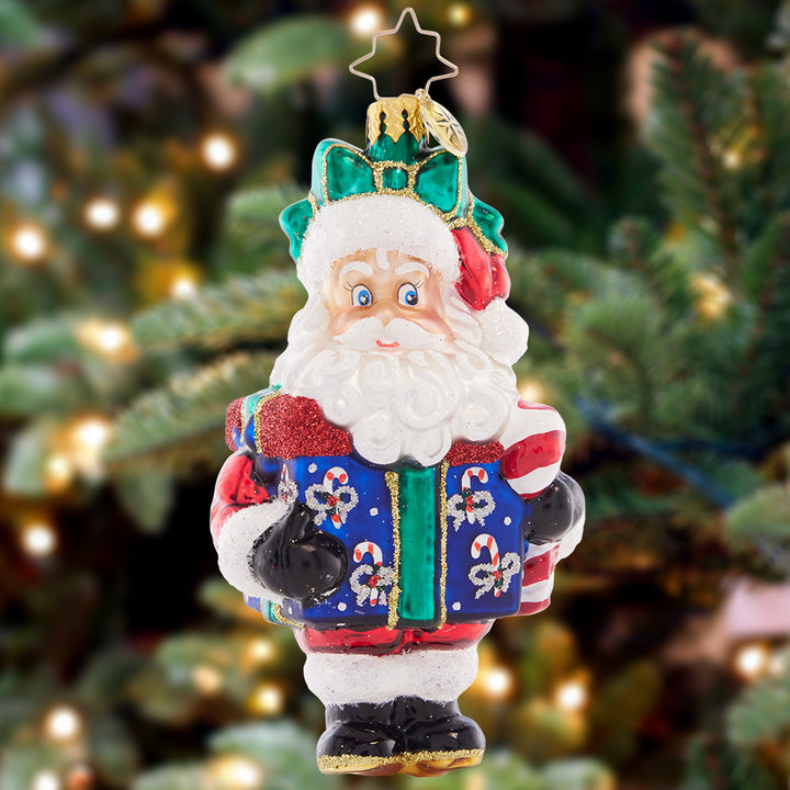 Ornament Description - Santa Surprise: Santa is boxed up and topped with a bow, the greatest gift to give a friend or adorn your own tree.