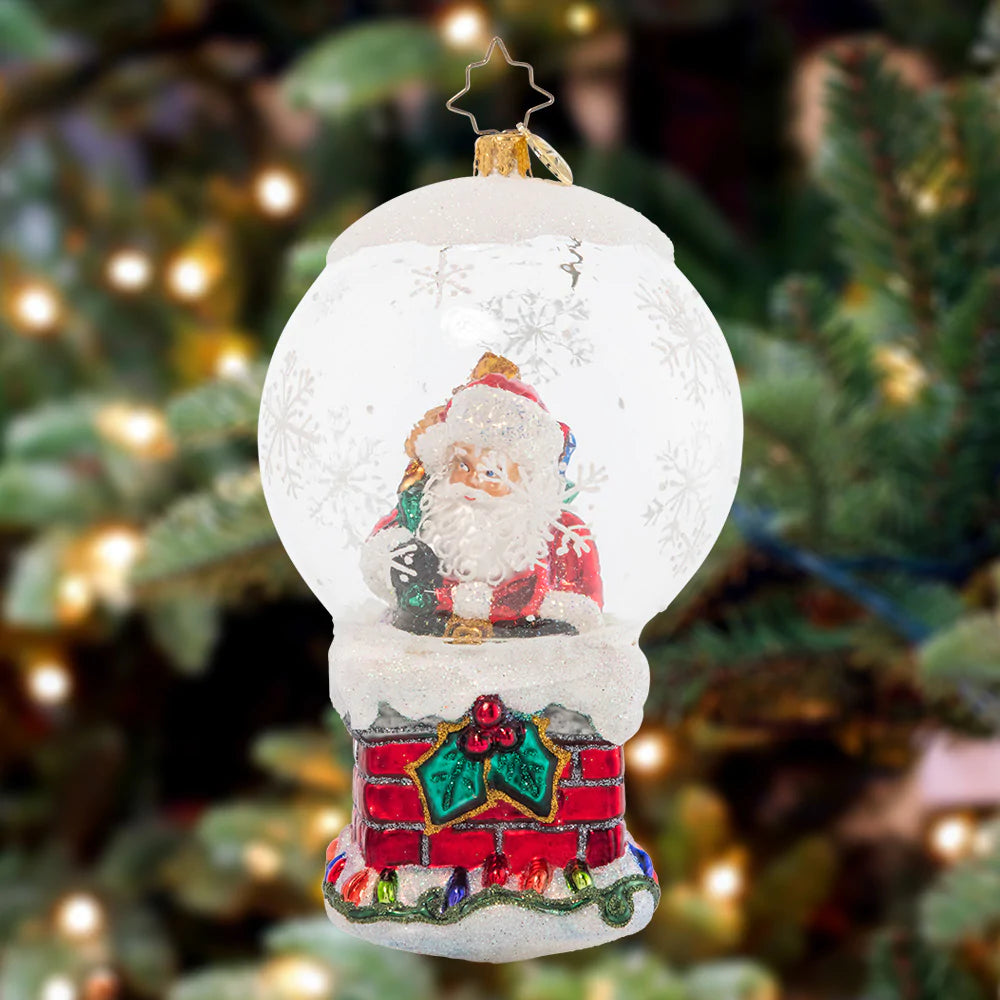 Ornament Description - Up On The Housetop: It's a bit of a tight squeeze for Santa to fit down the chimney – not because he's been eating Christmas cookies, but because of his bountiful bag of gifts, of course!
