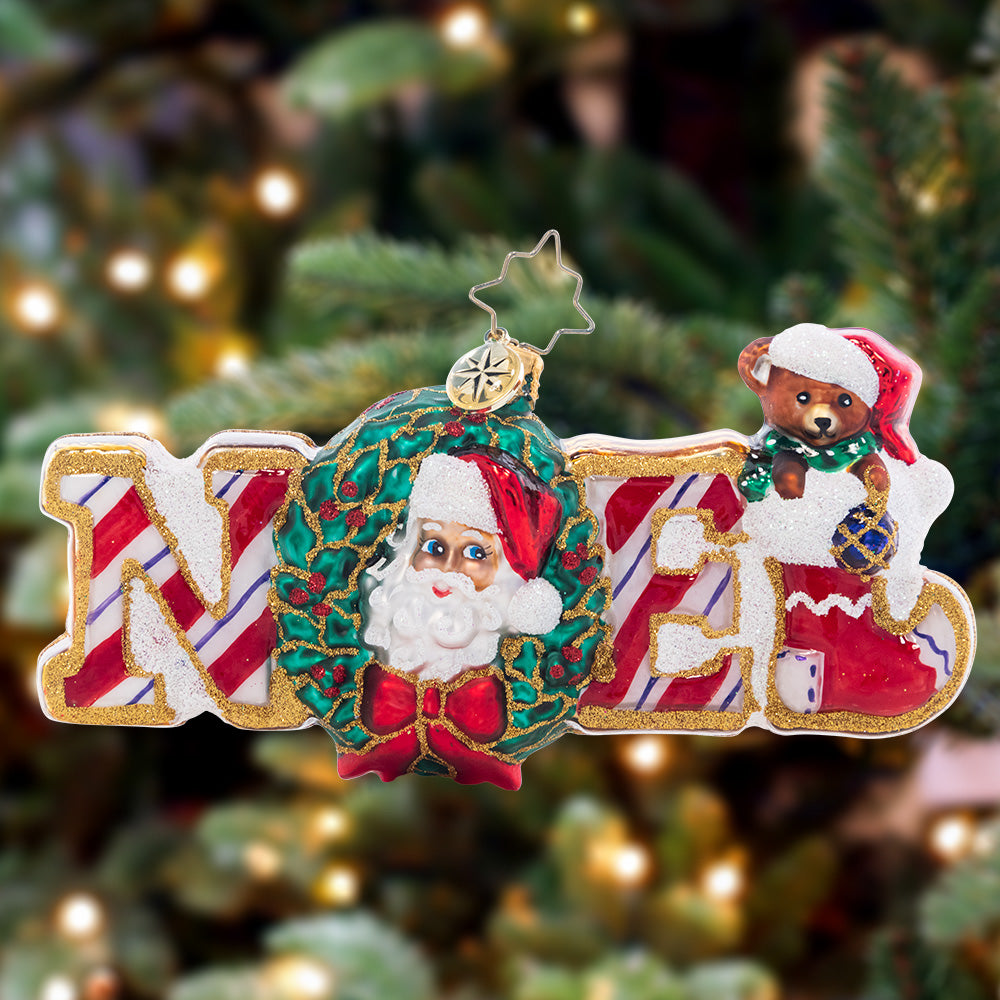 Ornament Description - Christmas Traditions Noel: Spelling the traditional name for "Christmas" in sweet gingerbread and peppermint, this Noel ornament is the perfect way to celebrate the special day.