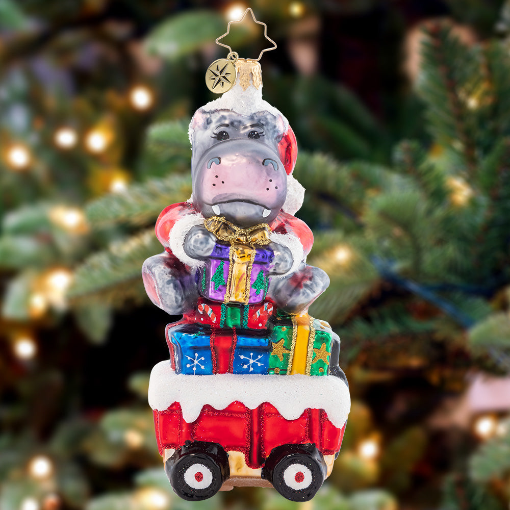 Ornament Description - Holiday Hippo on the Go!: Holiday Hippo has places to go and people to see. Rolling on by it's quite a sight to behold and will make you laugh with glee.