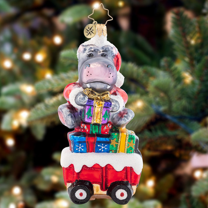 Ornament Description - Holiday Hippo on the Go!: Holiday Hippo has places to go and people to see. Rolling on by it's quite a sight to behold and will make you laugh with glee.