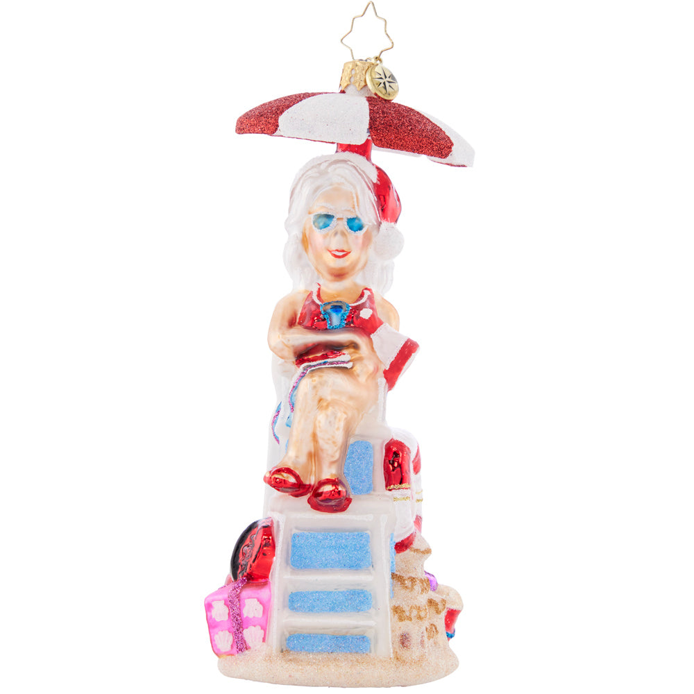 Front - Ornament Description - Lovely Lifeguard: Staying cool under a parasol in her stylish shades, Mrs. Claus is keeping a close eye on the crashing waves.