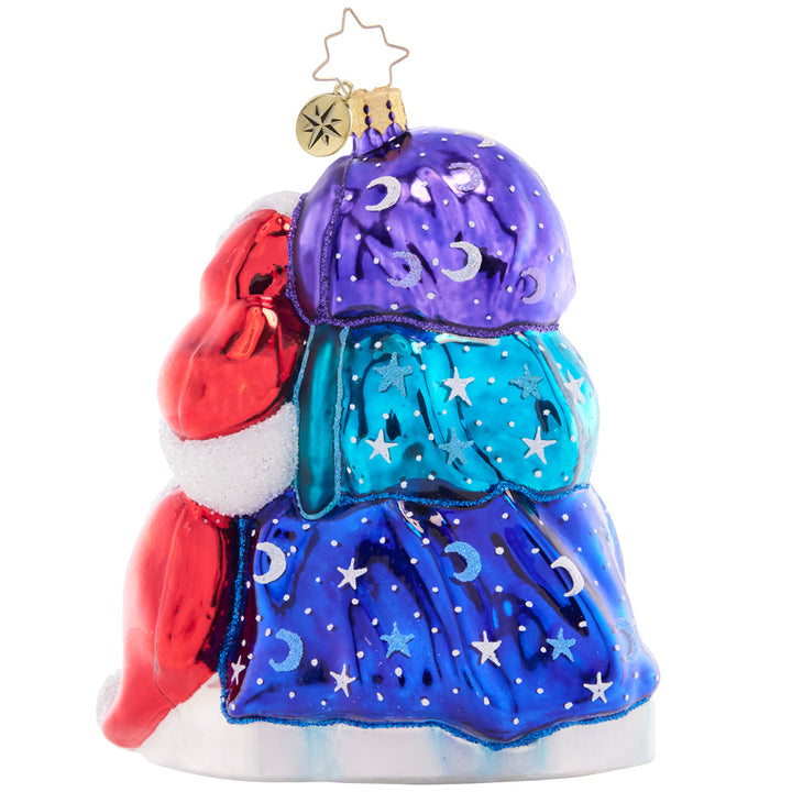 Back - Ornament Description - Piled High Polar Bears: Snuggled under star-speckled blankets, this trio of polar bears are sleeping soundly as they await the excitement of Christmas morning.