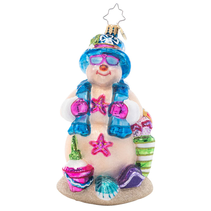 Front - Ornament Description - Beach Day Snow Friend: Basking in the sunshine, this sand-colored Snowman is happy to have a break from the cold winter weather! He's ready for the perfect beach day with a pail and shovel for sandcastle building.