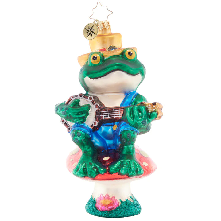 Front - Ornament Description - Bayou Banjo Blues: Perched atop a mushroom as his stage, this fun frog gives his audience a bravo-worthy banjo performance on the bayou.