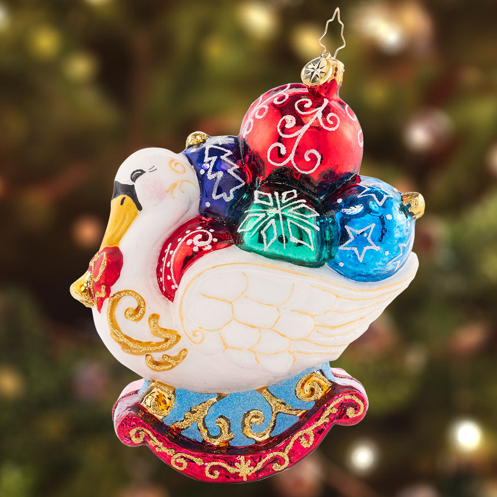 Ornament Description - Festive Feathers - 2023: What could be prettier than a festive swan who has gathered Christmas ornaments to flaunt among her feathers? This bird will compete with any tree for the best decorated, as you can see!