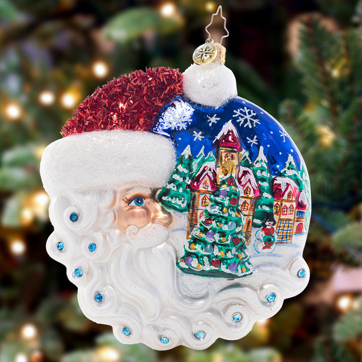 Ornament Description - Christmas Village Santa: Looking out wistfully upon a cozy Christmas village, this crescent-moon Santa is the guardian of a holy night.