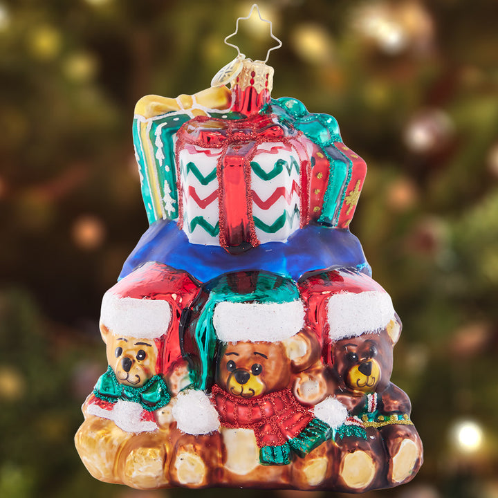 Ornament Description - Bear Hugs Abound: Three little bears surround this bag of ornately decorated Christmas gifts – the cutest addition to your tree!