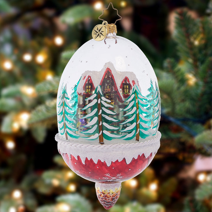 Ornament Description - Winter Cottage Hideaway: Ensconced within a snow-filled dome, this cozy chalet surrounded by pine trees makes for a stunning winter scene. This special ornament has been hand-picked by the Radko team to be part of the Limited Edition collection.