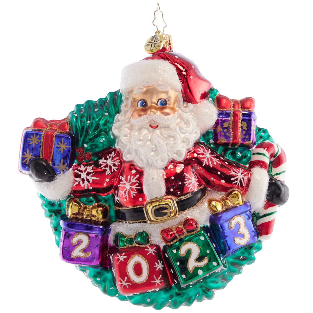 Front - Ornament Description - Yearly Salutations: With arms spread wide full of Christmas cheer, Santa is looking ahead to an extra bright year! Adorn your tree with this darling dated piece.