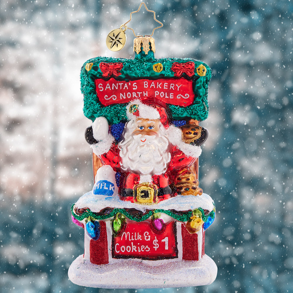 Ornament Description - Santa's Sweet Treat Stand: After sampling Christmas cookies from around the world, Santa has worked out the tastiest secret recipe. Stop by his cookie stand for a sweet treat and a tall glass of milk, and get into the holiday spirit!