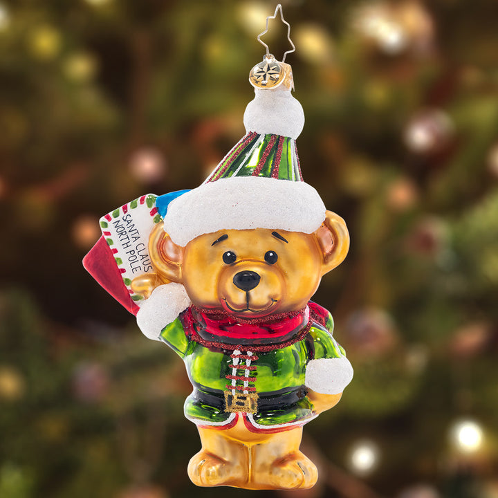 Ornament Description - Beary Good Helper: Dressed in his finest elf attire, this sweet little bear is delivering Christmas lists to Santa!