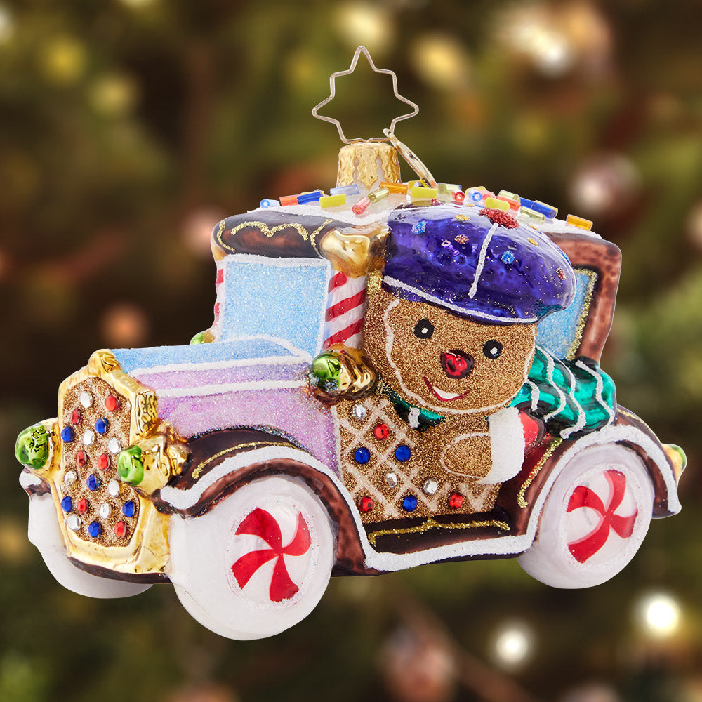 Ornament Description - The Treatmobile: Beep beep! With shimmering peppermint rims and gumdrop detailing, this sugar-powered cookie car is one sweet ride.
