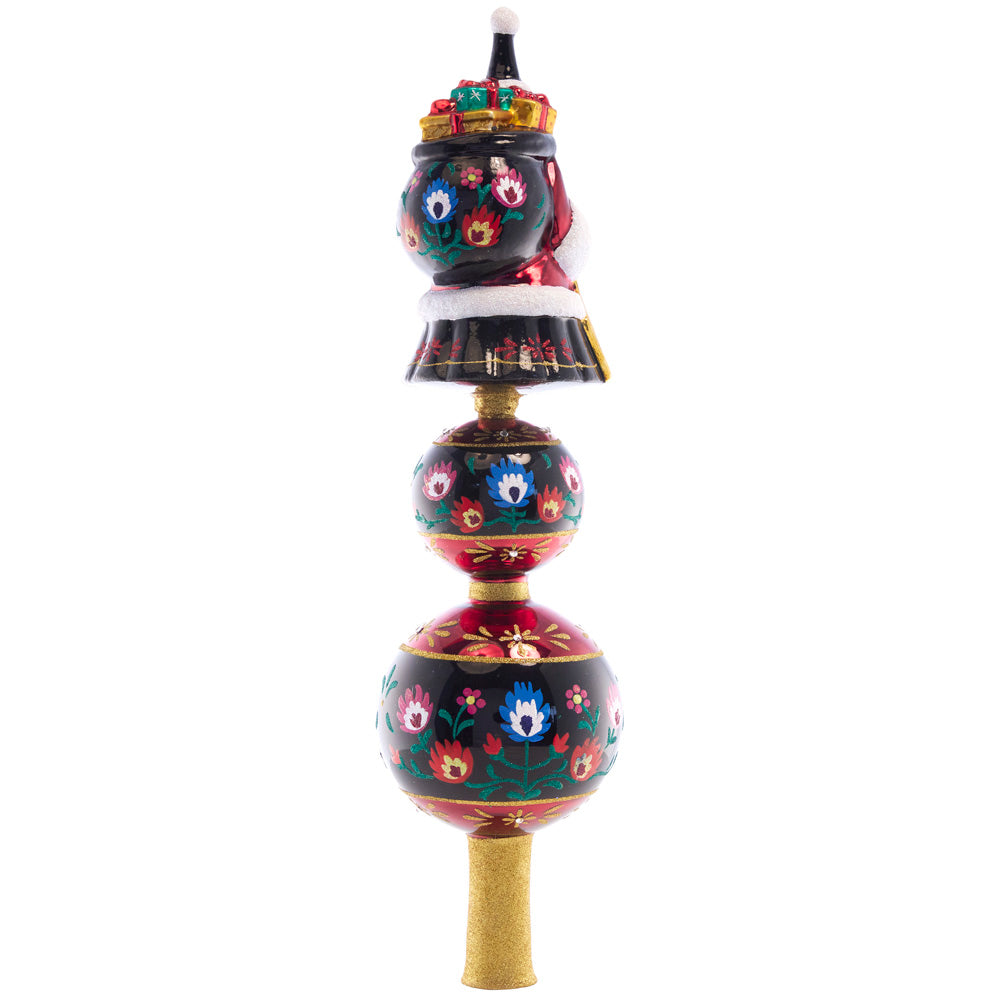 Back - Finial Description - Festive Folk Art Santa Finial: Our 2022 Designer's Choice ornament is back on top of the tree! Enjoy this beloved European Christmas folk art fairytale finial with a one-of-a-kind festive design.