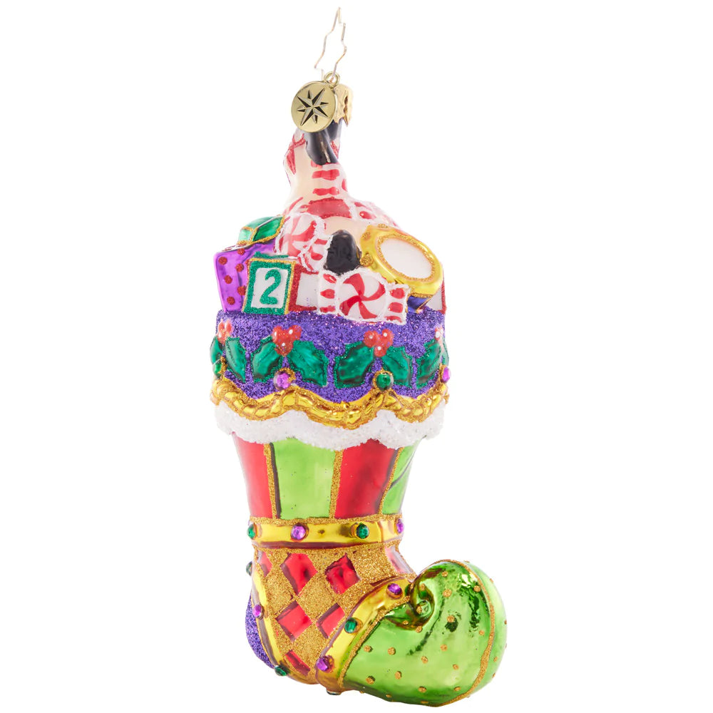 Front - Ornament Description - Over-Stuffed Stocking: Toys galore, a joyful surprise, straight from Santa's elves' supplies. May your stocking be overflowing with gifts as Santa checks off every list.