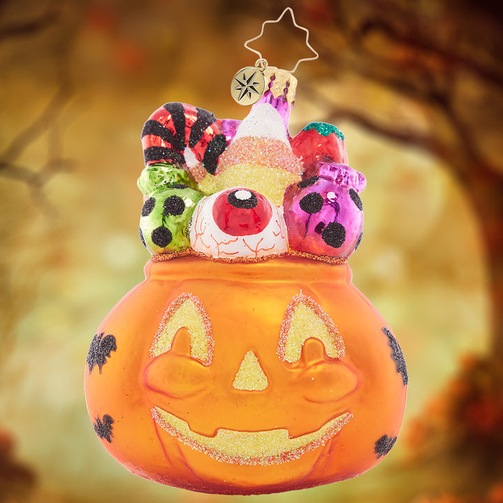 Ornament Description - Trick or Treat Sweets: This ghoulish jack-o-lantern is filled with tricks and treats – take a handful if you dare!