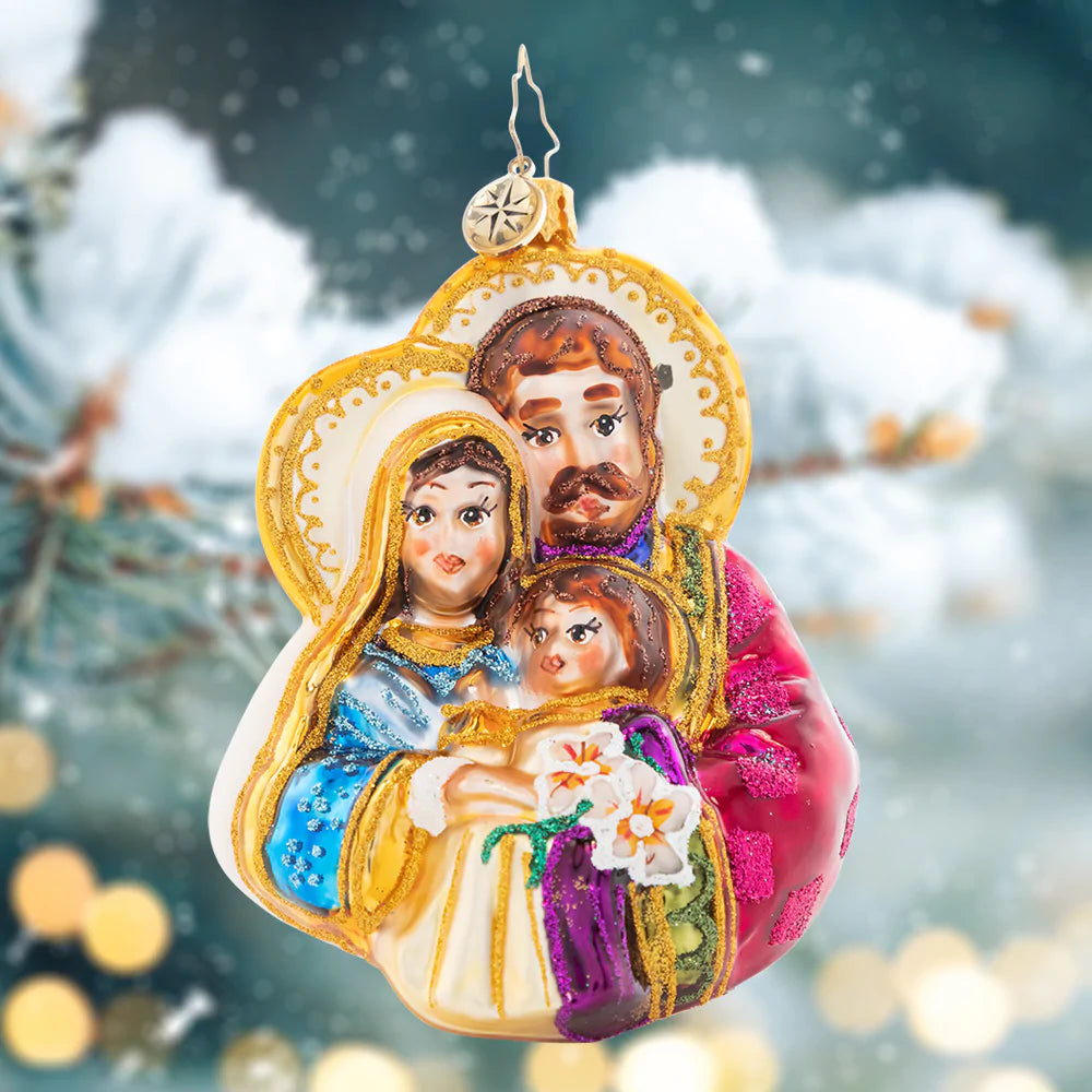 Ornament Description - The Love of a Family: Rejoice! Mary and Joseph cradle baby Christ, reveling in his light and the love of a family.