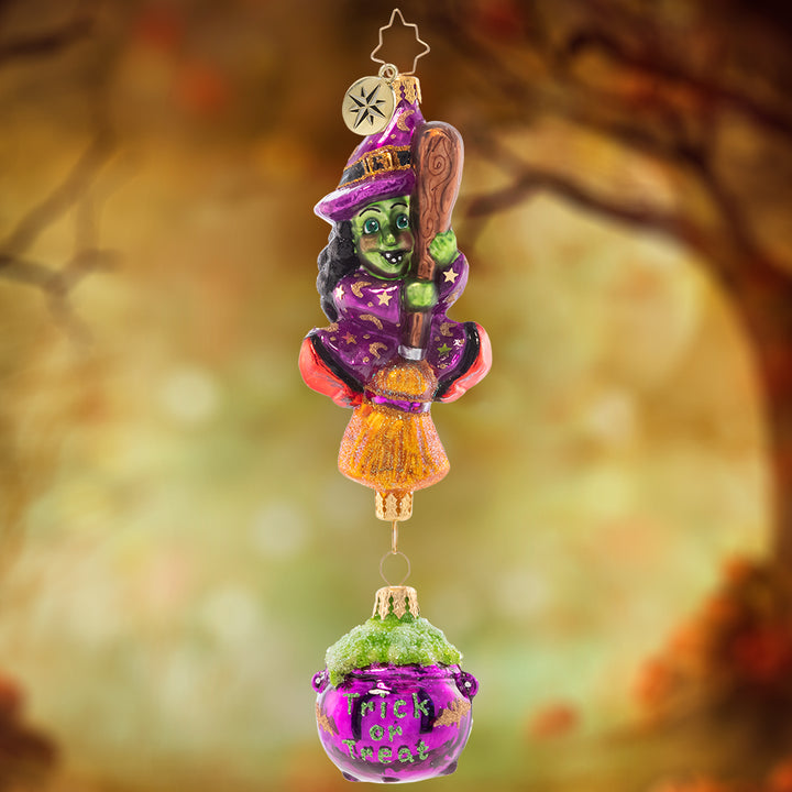 Ornament Description - Witchy Woman: With broom and cauldron in hand, this witch is ready to bring Halloween throughout the land. She'll give you a trick or a treat – let's hope you get something sweet!