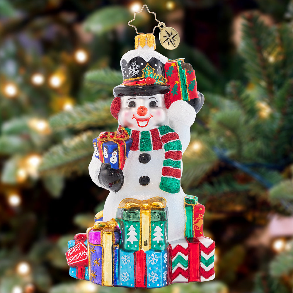 Ornament Description - Wrapped And Ready Snowman: This festive snowman has a gift giving gameplan. He'll show up at your door to spread Christmas cheer galore.