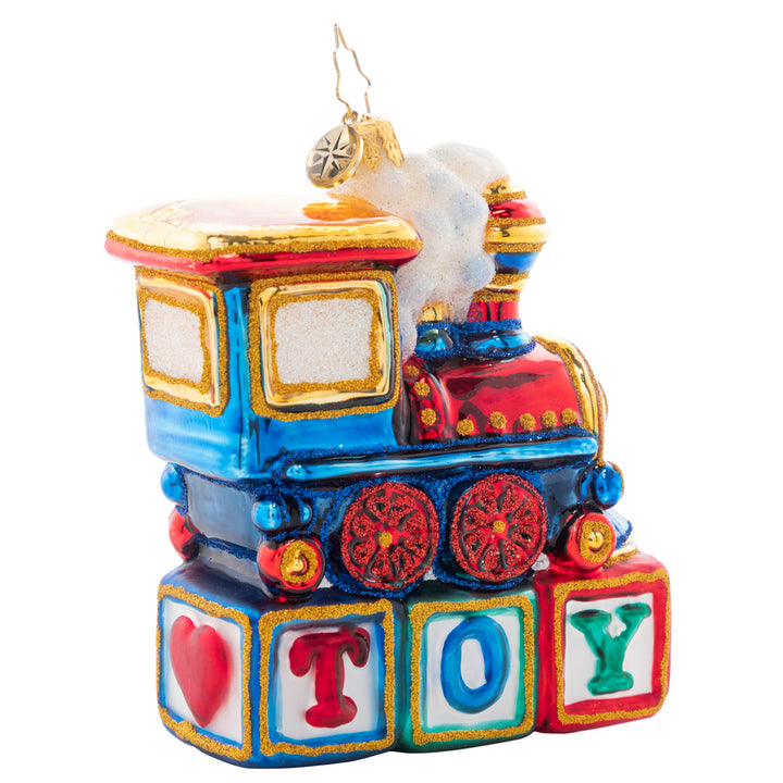 Back - Ornament Description - Choo Choo Cheer: This little locomotive is perched atop colorful wood blocks, making the perfect Christmas gift for any toy-loving tot.