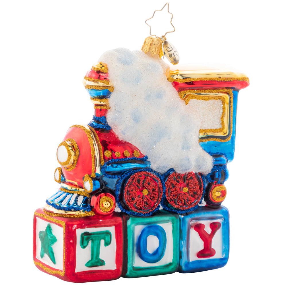 Front - Ornament Description - Choo Choo Cheer: This little locomotive is perched atop colorful wood blocks, making the perfect Christmas gift for any toy-loving tot.
