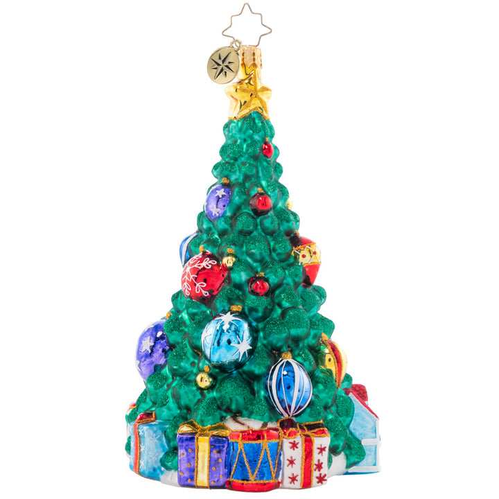 Back - Ornament Description - Tastefully Trimmed Tree: A tree lined with toys fills a child's heart with great joy! With presents ready to delight this tree shines from the greatest of heights.