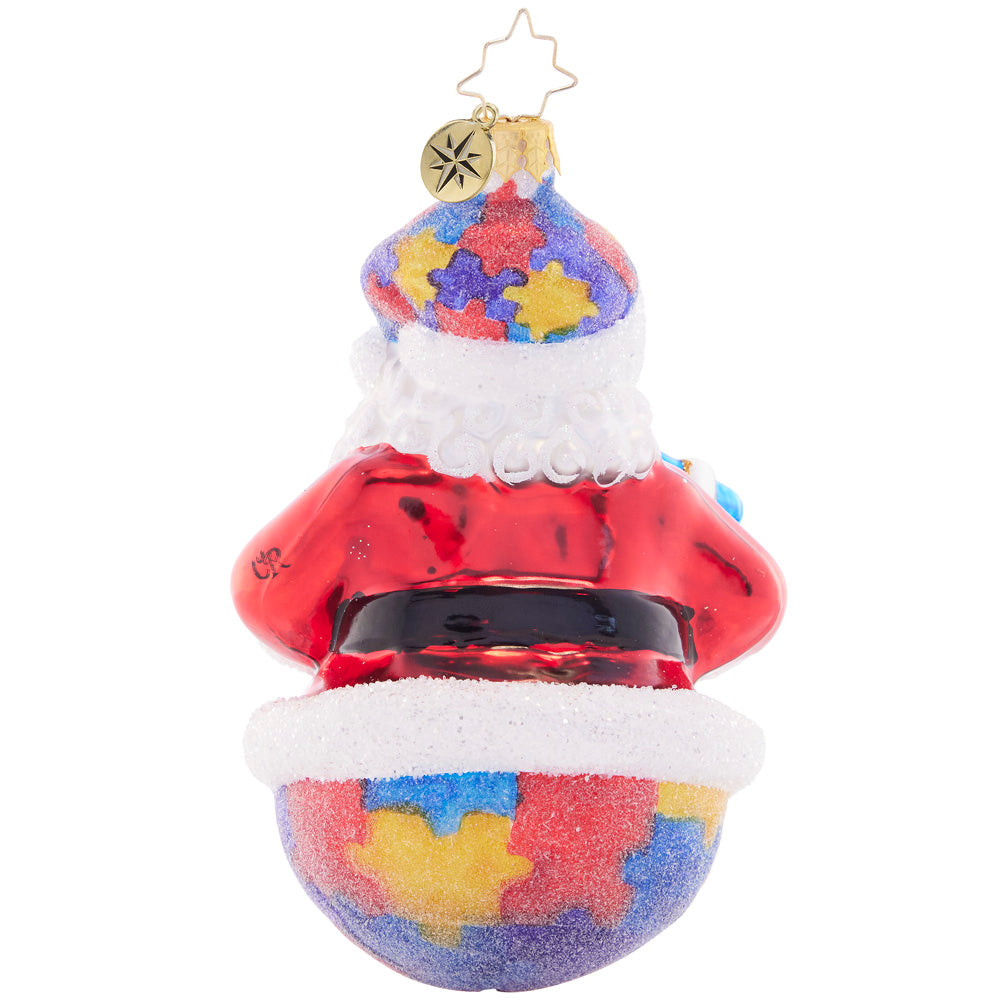 Back - Ornament Description - Perfect Pieces: This perfectly unique puzzle piece santa celebrates the strength and beauty of neurodiversity. A percentage of the sales from this ornament will benefit a charity that raises Autism awareness.