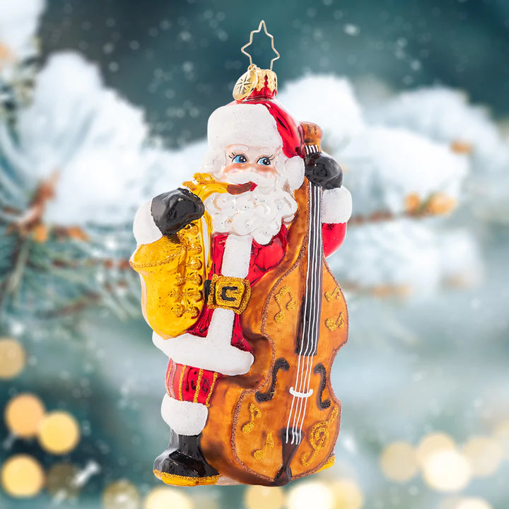 Ornament Description - Merry Music Maker: Holding a saxophone and a standing bass, this Santa sure is extra jazzy! Adorn your tree with this whimsical piece and celebrate the songs of the holiday season.