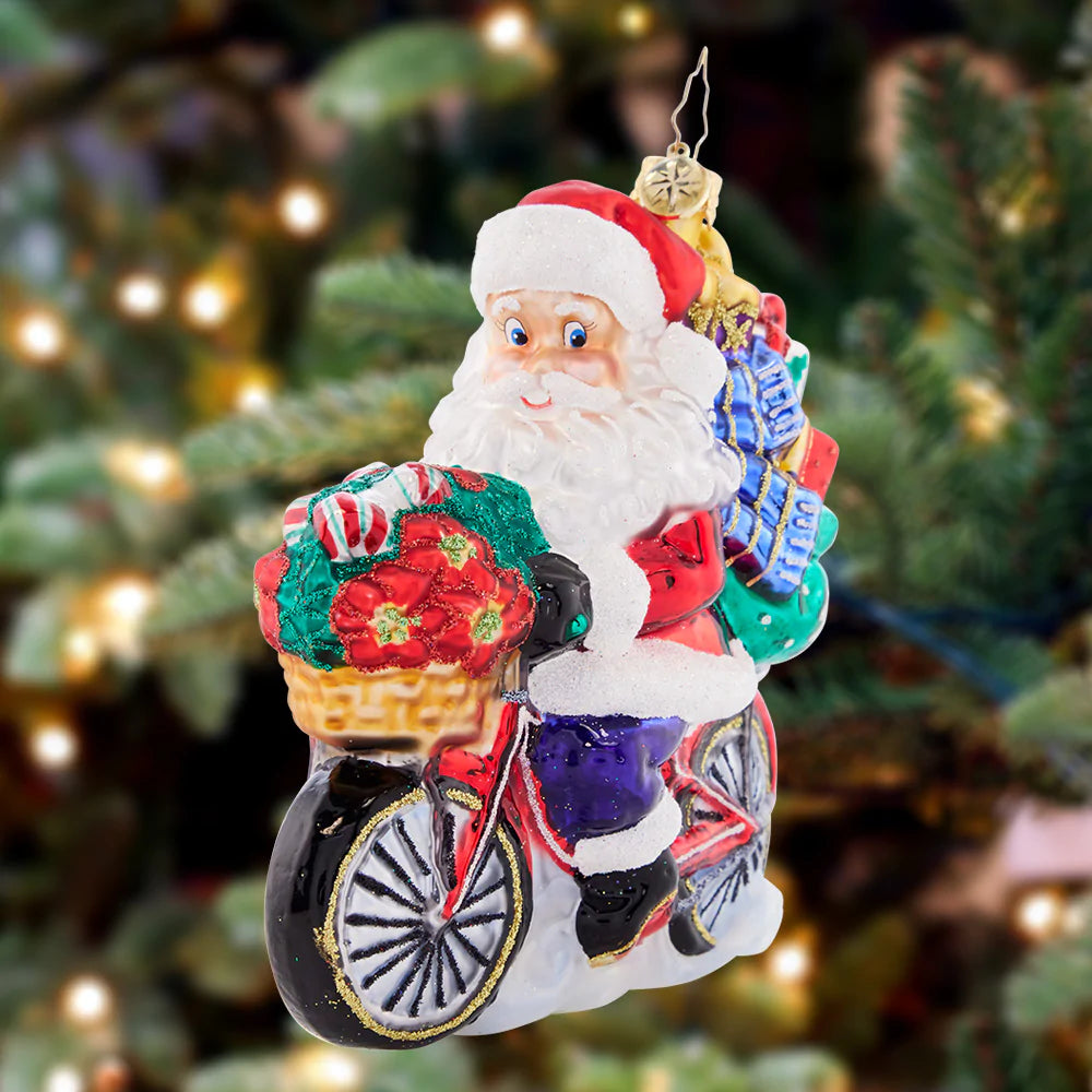 Ornament Description - Santa's Ride Around Town: Cruising down the boulevard on his 10-speed, Santa is delivering perfectly-packed presents in eco-friendly style. Celebrate the cyclists in your life with this whimsical ornament!