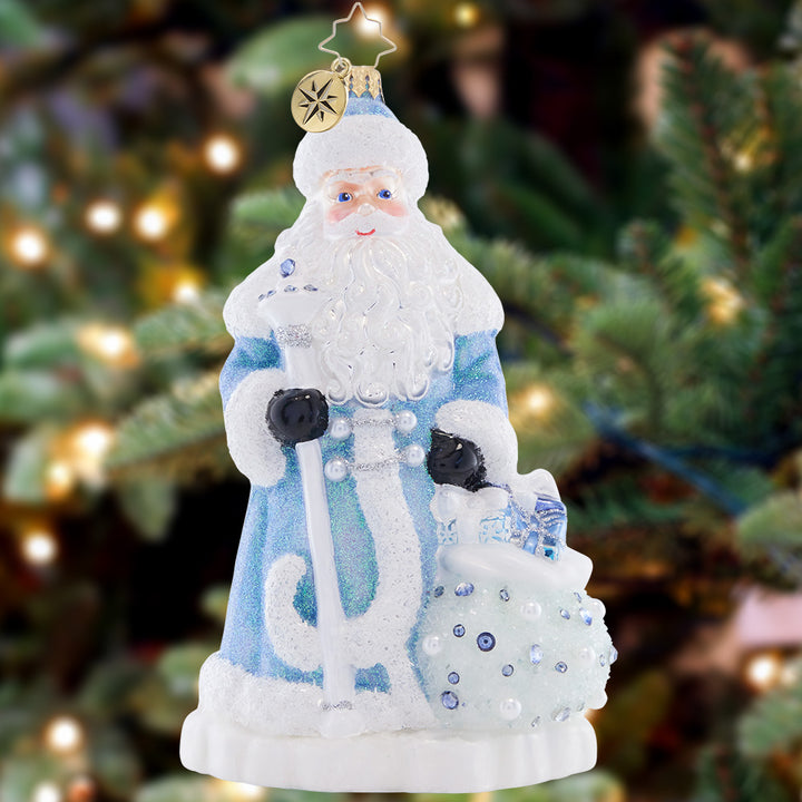 Ornament Description - Frosty Father Christmas: Illuminated by an extravagant, icy blue coat and a glittered bag of gifts, this Santa shines brighter than freshly fallen snow.