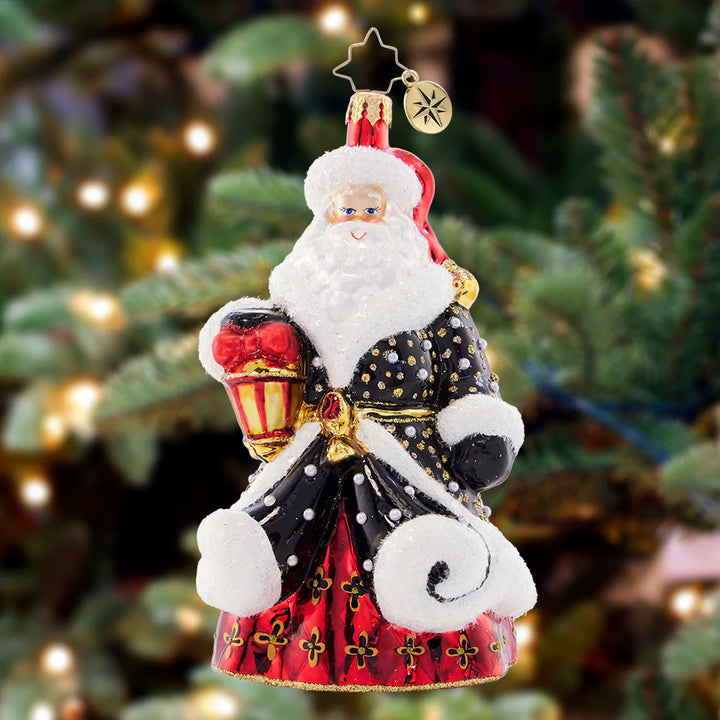 Ornament Description - Golden Glow Santa: Santa's black robe is studded with silver and gold, resembling a starry sky on a cold winter night. He's got his trusty lamp to light the way this holiday season.