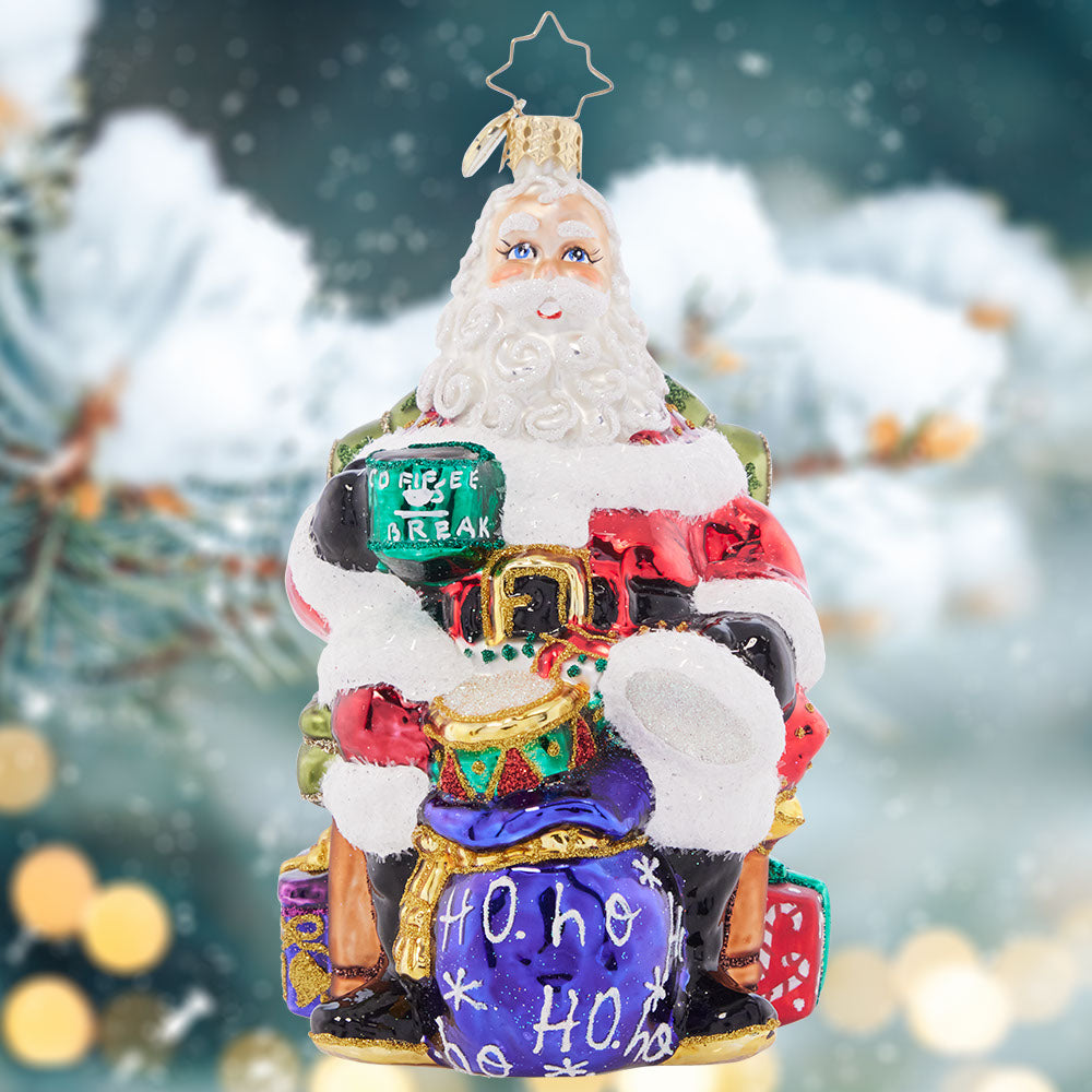 Ornament Description - Break Time Santa: Hats off to a much needed coffee break! Santa takes a moment to sit back and relax with a steaming hot cup of joe before returning to his important present wrapping tasks.