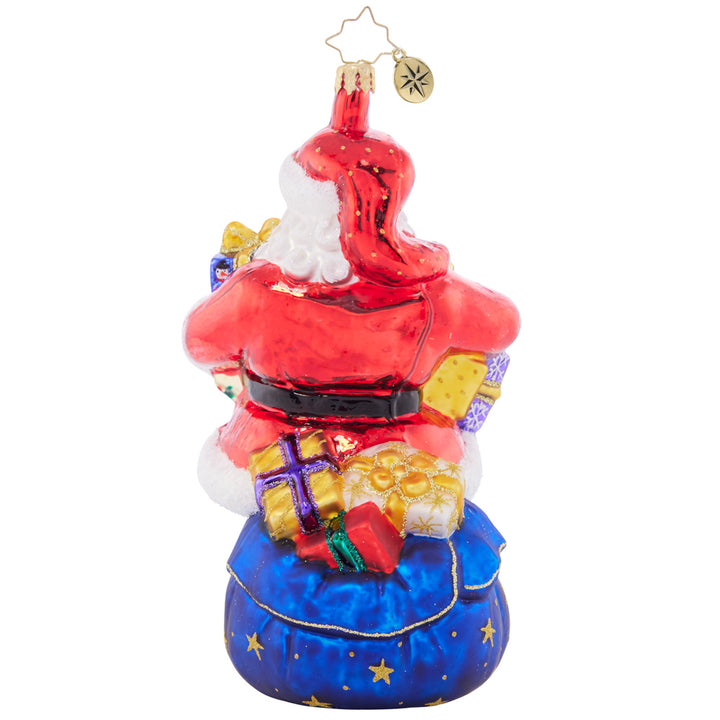 Back - Ornament Description - Carrying Christmas: As you can tell by his arms overflowing with gifts, Santa has his hands full this year! Not to worry, he'll get those gifts down the chimney in a hurry.