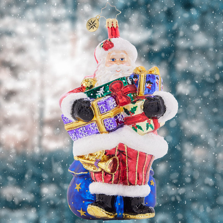 Ornament Description - Carrying Christmas: As you can tell by his arms overflowing with gifts, Santa has his hands full this year! Not to worry, he'll get those gifts down the chimney in a hurry.