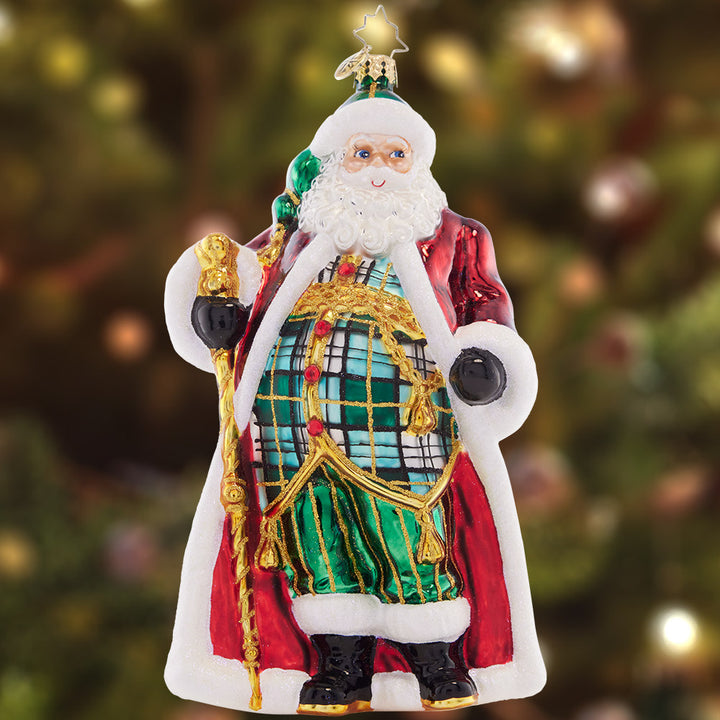 Ornament Description - Clad in Plaid: A new twist on classic style, this Santa is looking posh in his perfectly plaid vest, pants, and hat. He's still rocking his traditional red coat, but made extra special with gilded embellishments.