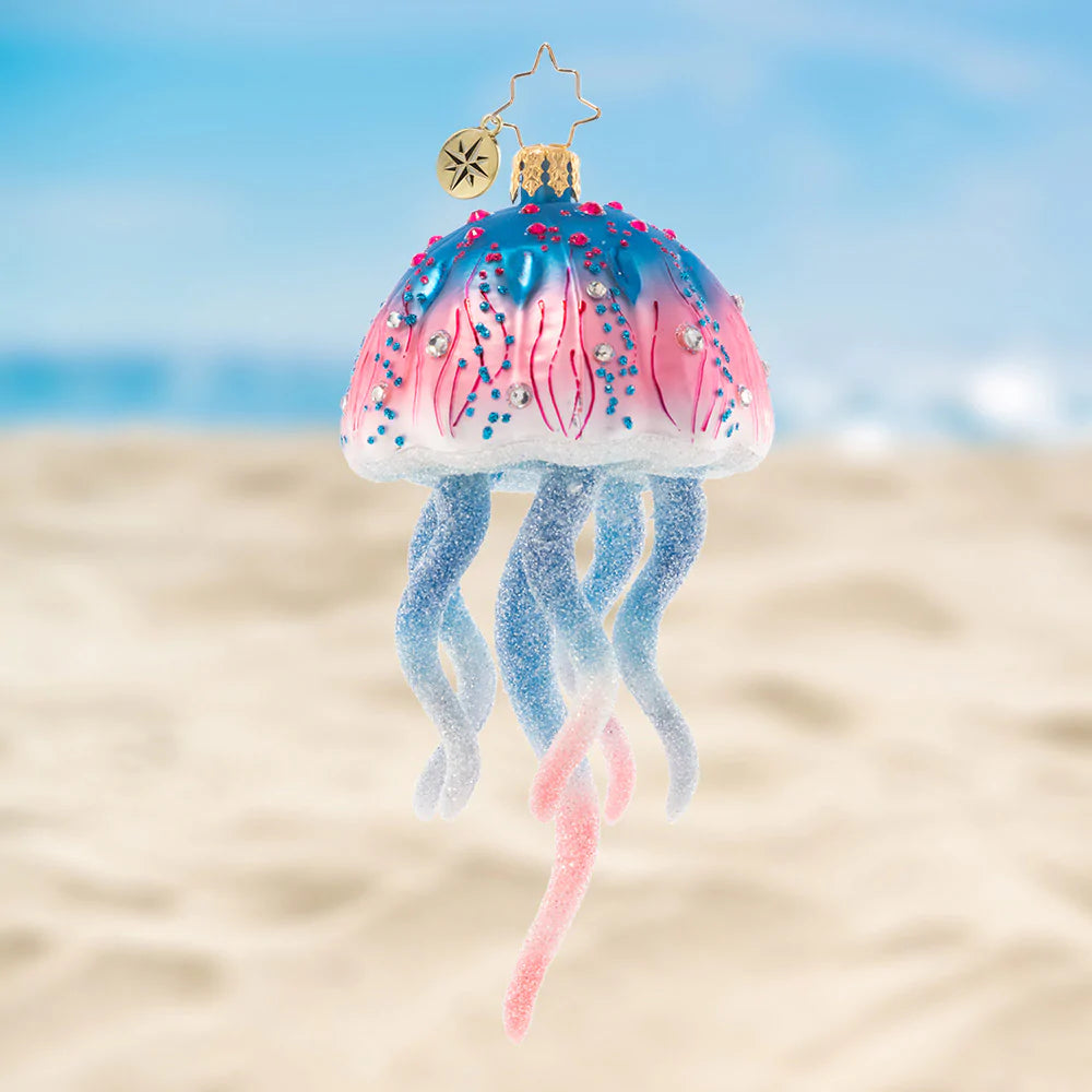 Ornament Description - Colorful Jelly: This joyful jellyfish is a jubilee of pink and blue hues. Let this stunning sea creature float among the boughs of the tree, bringing nautical cheer for all to see!