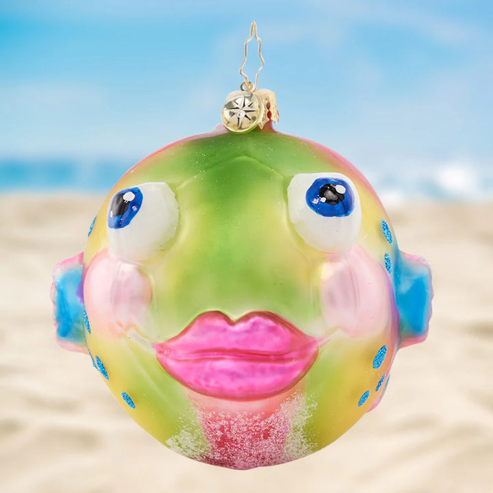 Onament Description - Playful Puffer: Pucker up, puffer fish! Painted with vibrant sorbet hues, this playful sea creature is sure to spread joy throughout the holiday season.