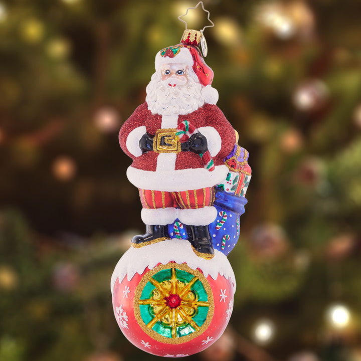 Ornament Description - On Top of it Santa: With his bustling, busy holiday schedule, Santa must be on the ball when delivering his gifts. Not to worry, though, he's been doing this for a long time!