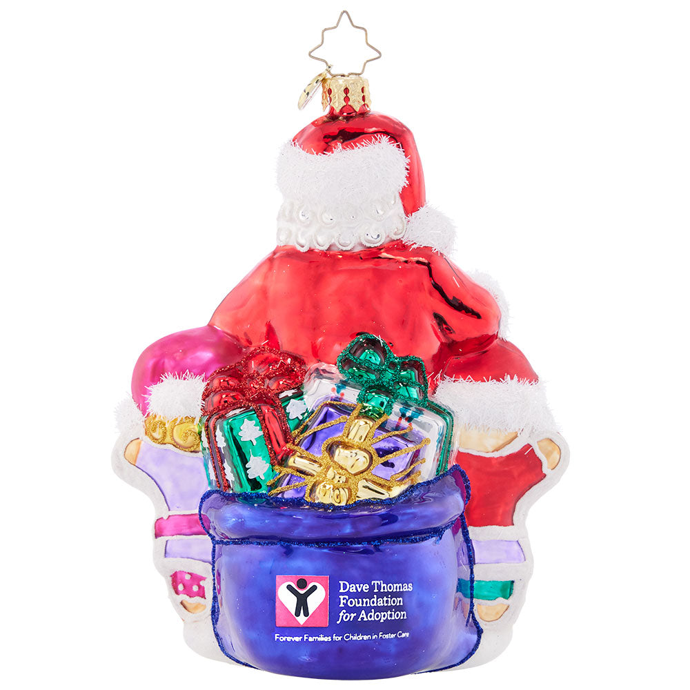 Back - Ornament Description - Room for One More - Dave Thomas Adoption :Santa works hard to get all around the world in one night, delivering toys and spreading holiday joy! He always has room for an extra Christmas cookie – a well-earned treat. A percentage of the sales from this ornament will benefit the Dave Thomas Foundation for Adoption.