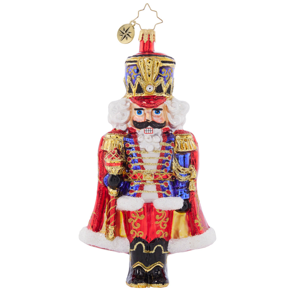 Front - Ornament Description - Holiday Elegance Nutcracker: With his royally resplendant red cape, this classic Christmas nutcracker is the perfect protector to place among the boughs of your tree.