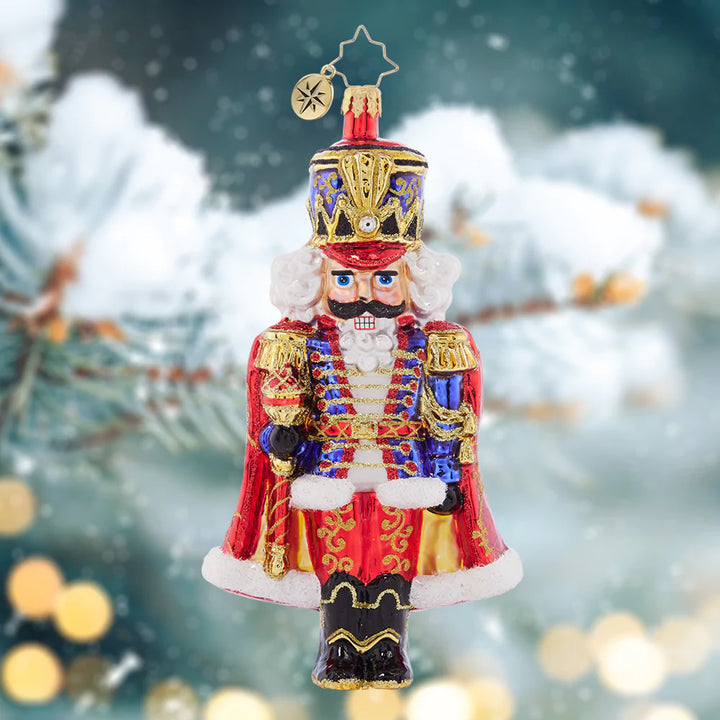 Ornament Description - Holiday Elegance Nutcracker: With his royally resplendant red cape, this classic Christmas nutcracker is the perfect protector to place among the boughs of your tree.