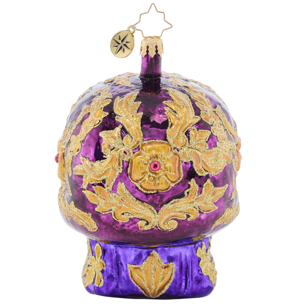 Back - Ornament Description - Festive Filigree Calavera: Looking fancy as ever with glowing golden eyes and stunning glittered swirls, this Calavera ornament is a frightfully festive piece to feature on your tree.