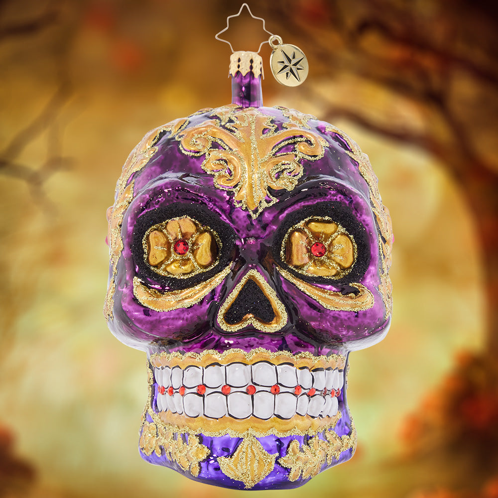Ornament Description - Festive Filigree Calavera: Looking fancy as ever with glowing golden eyes and stunning glittered swirls, this Calavera ornament is a frightfully festive piece to feature on your tree.