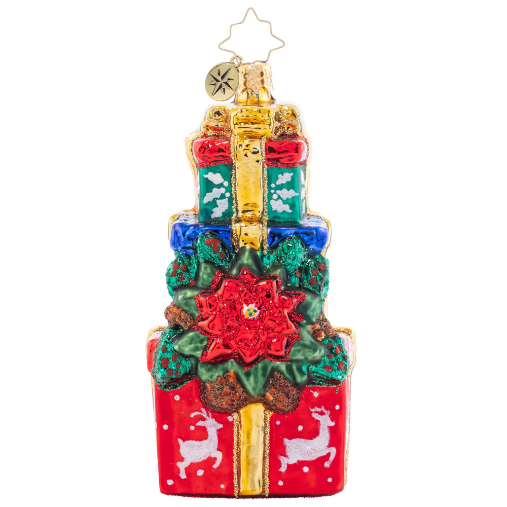 Front - Ornament Description - Poinsettia Presents: Perched atop this perfect pile of gifts is a pretty Poinsettia plant! Add a pop of crimson color to your tree with this beautiful ornament.