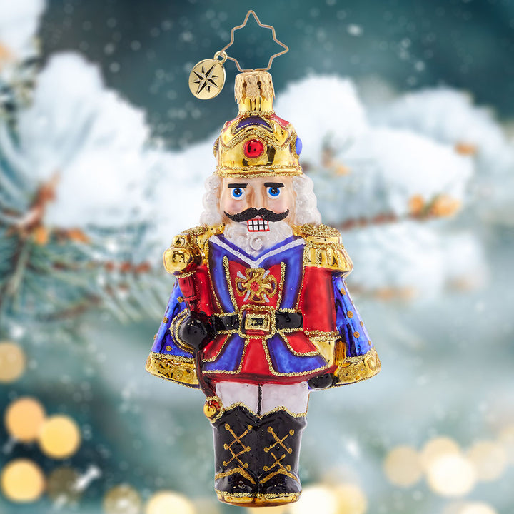 Ornament Description - Christmas Classic 'Cracker: Time to get crackin' on some present unwrapping! This classic nutcracker is ready to celebrate, marvelously mustachioed and donning a red and blue cloak.