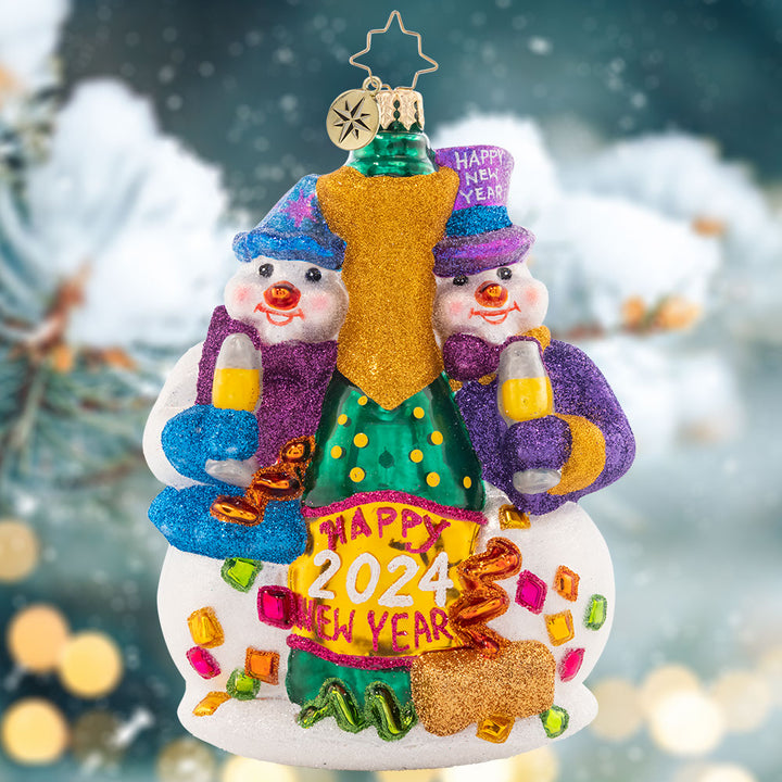Ornament Description - New Year's Toast: Two festive snow-friends are ringing in the new year with a big bottle of bubbly! Commemorate another wonderful year with this cute, cozy ornament.