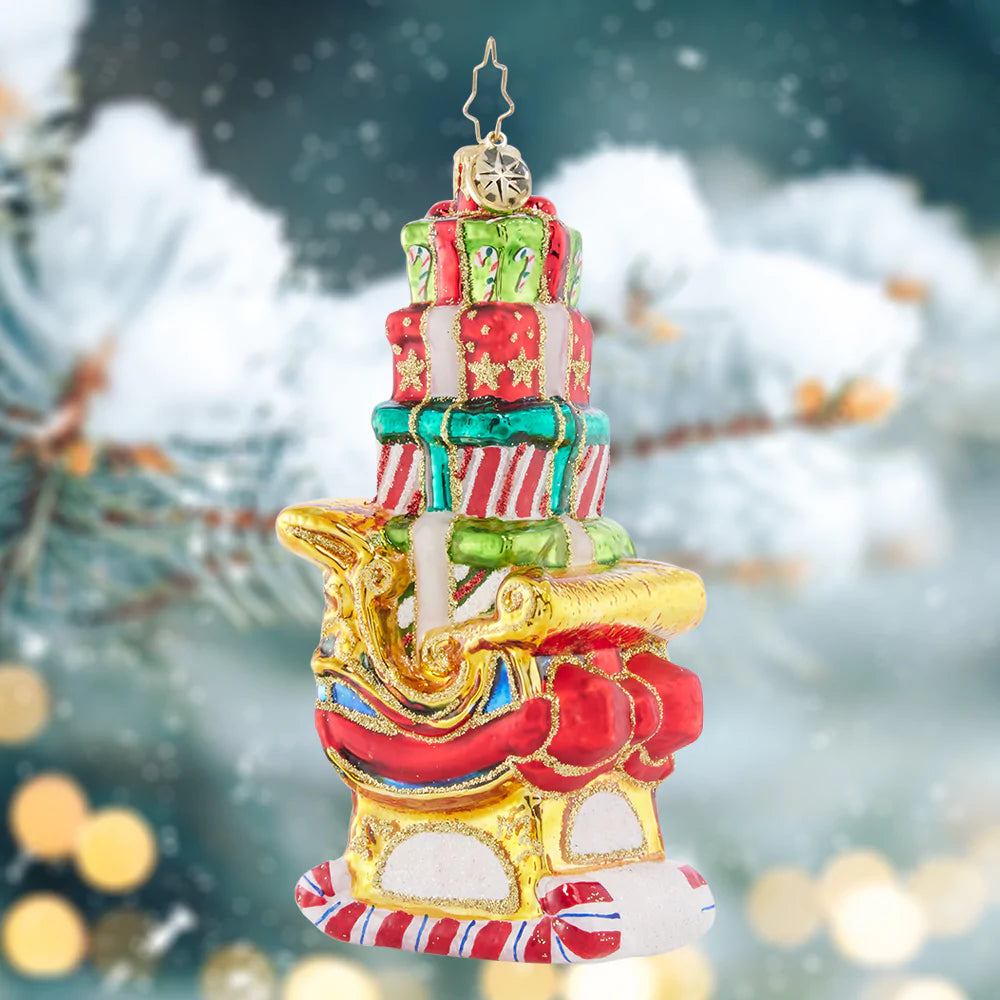 Ornament Description - Piled-High Sleigh: Look at that perfectly-stacked plethora of presents! This super-stocked sleigh is ready to save Christmas day, ensuring that Santa can get all of the gifts delivered swiftly around the world.