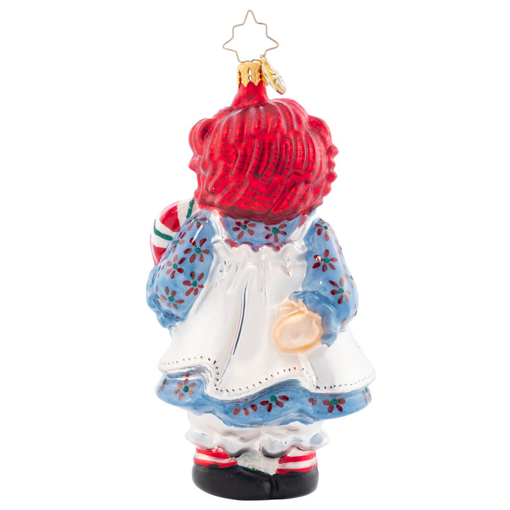 Back - Ornament Description - Raggedy Sweets: This timeless sweetie has her own sweets this Christmas. Share the love and childlike wonder this season with Raggedy Ann. She got all "dolled" up for you in her best holiday dress and apron!