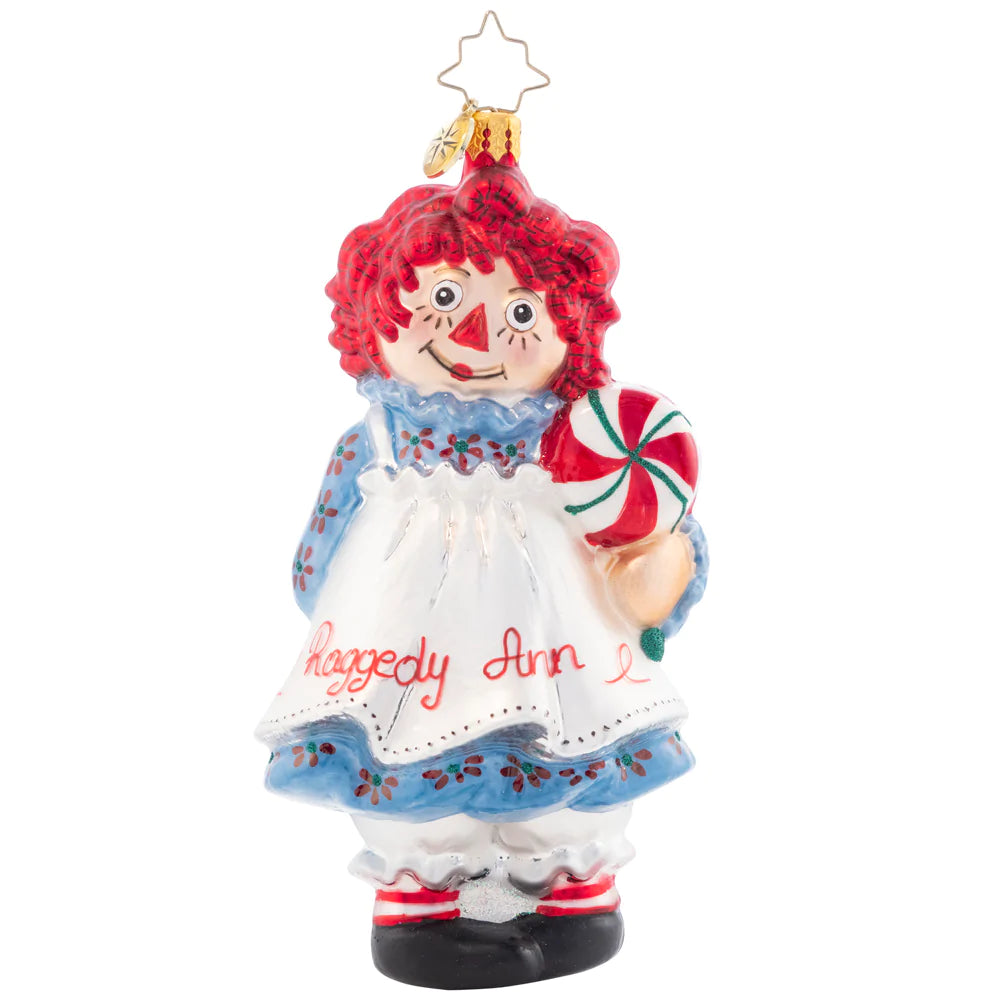 Front - Ornament Description - Raggedy Sweets: This timeless sweetie has her own sweets this Christmas. Share the love and childlike wonder this season with Raggedy Ann. She got all "dolled" up for you in her best holiday dress and apron!