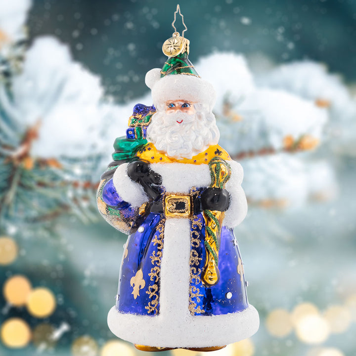 Ornament Description - Lynn's Luxurious St. Nick: In a royal blue hue decorated with festive Fleur de Lis, this darling Santa is sure to bring luxurious style to your tree. Lynn Brammer gets the credit for this beautiful design!